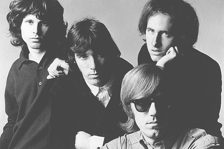 The members of The Doors, from left to right: Jim Morrison, John Densmore, Robby Krieger and Ray Manzarek (seated). Michael Ochs Archives/Getty Images